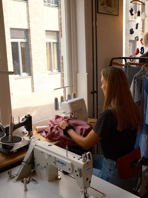 Lara aan de naaimachine in het atelier in Middelburg